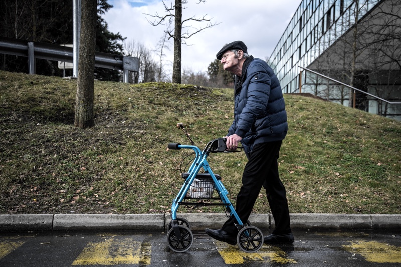 Roberto walking outdoors with his rollator