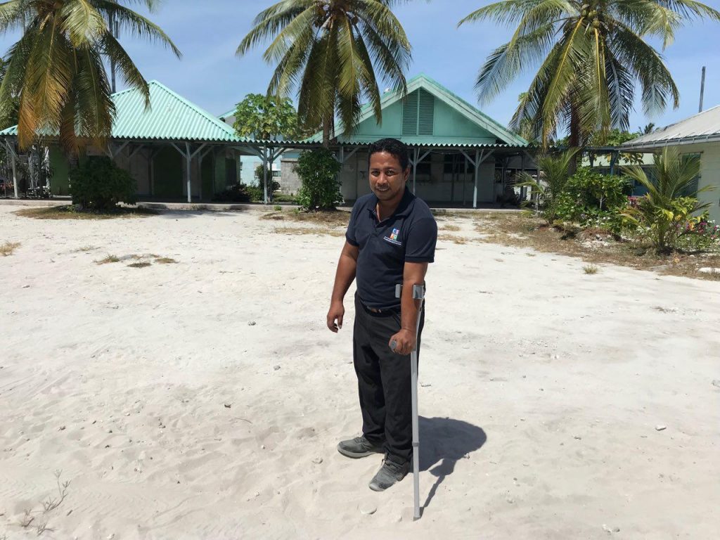 A forearm crutch being used in sand