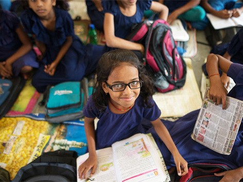 Young girl wearing glasses at school