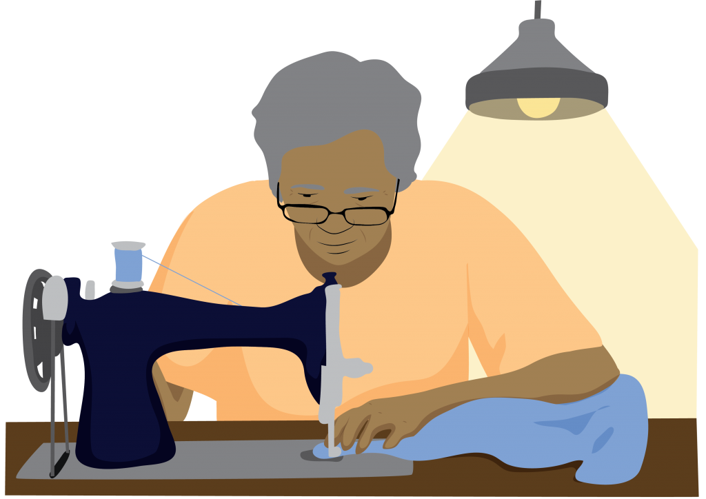 Malik working with a sewing machine with overhead light