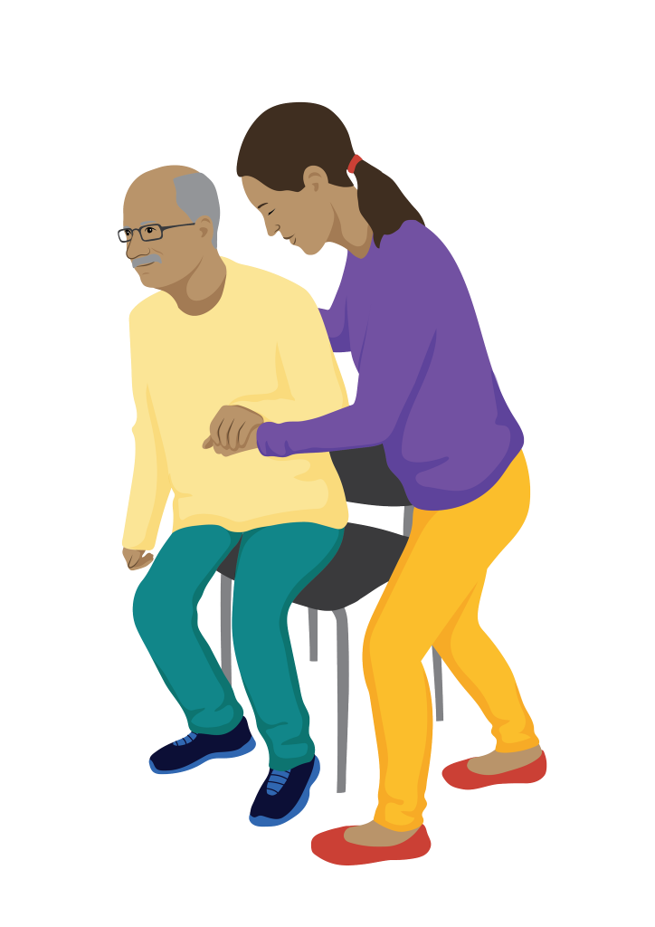 An older man is being helped to sit in a chair by a woman who is standing on his left side.