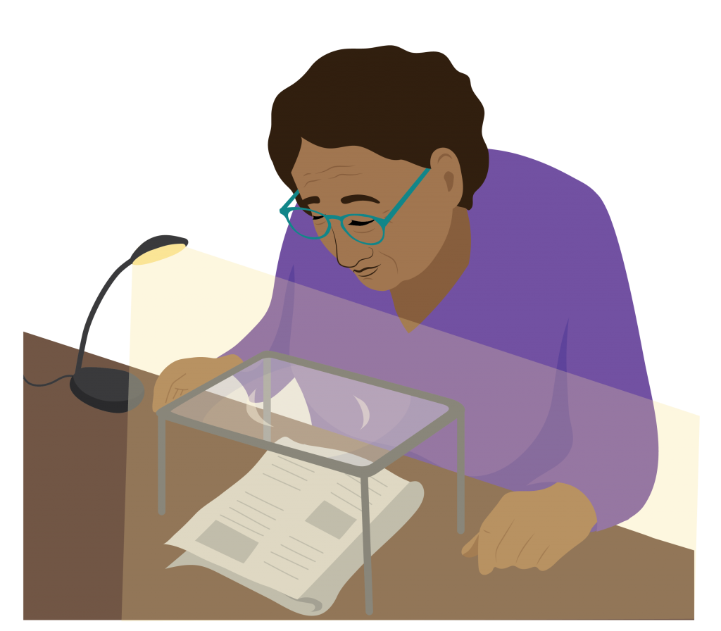 Joanna using her prescription spectacles, a stand magnifier and a lamp to read the newspaper.