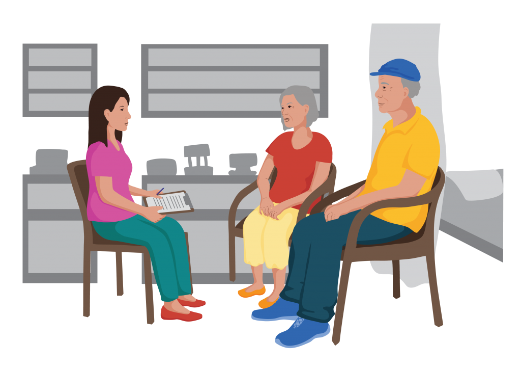 Mathias and his wife sitting in a health clinic talking to a nurse.
