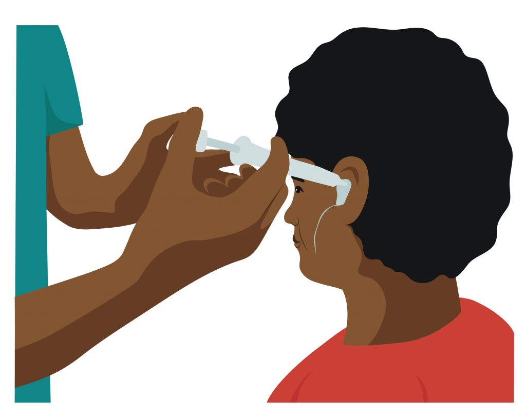 Health worker using a syringe to inject mould material into a person’s outer ear.