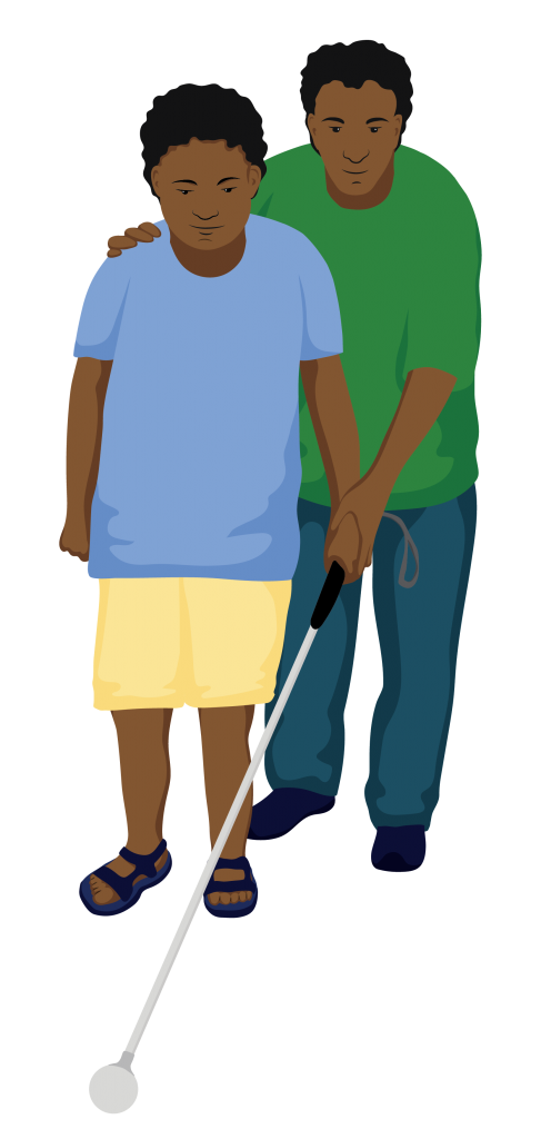 A service provider helps Michael try out a white cane. He has one hand on Michaels’ using the cane, and the other hand on Michael’s shoulder to help guide him.