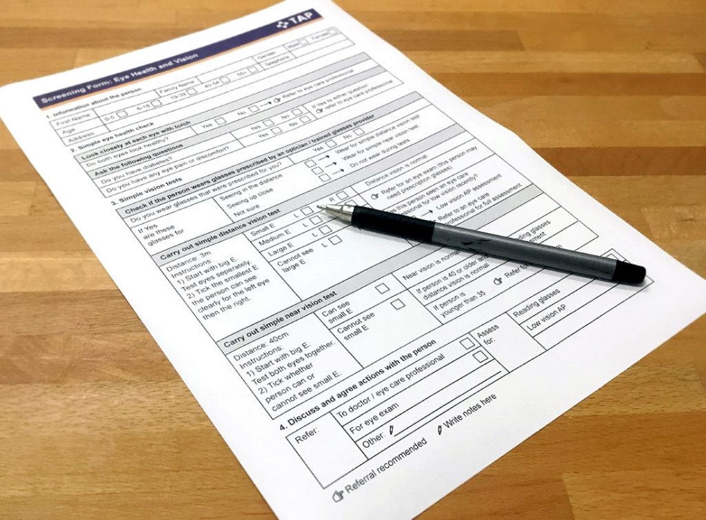 TAP vision screen form and pen on a table.