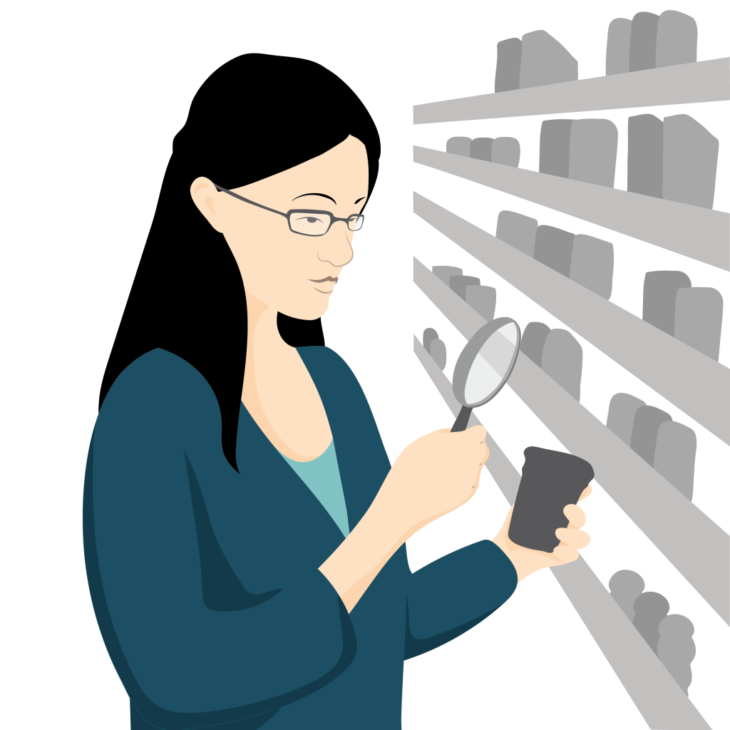 Ying wearing her prescription spectacles using a handheld magnifier to read a label on a product.