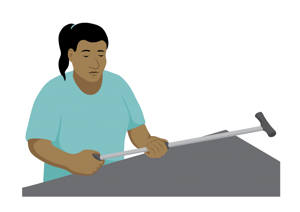 A service provider standing at a bench, holding a walking stick.