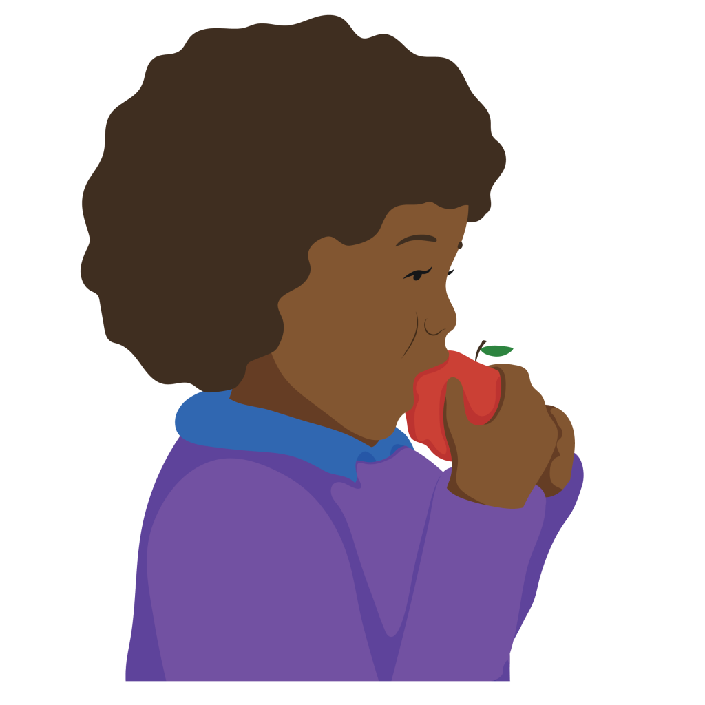 A young girl uses both hands to hold and eat an apple.