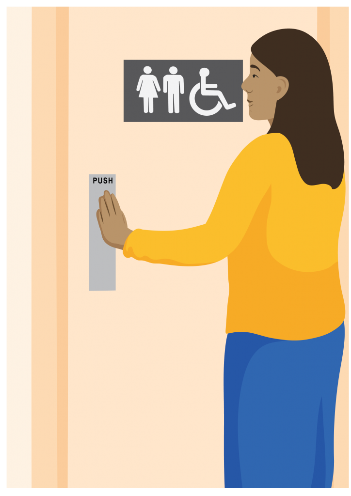 A person stands to push open a door displaying female, male and accessible symbols.