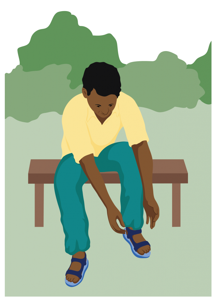 A man sitting on a bench leans forward to put on his sandals.