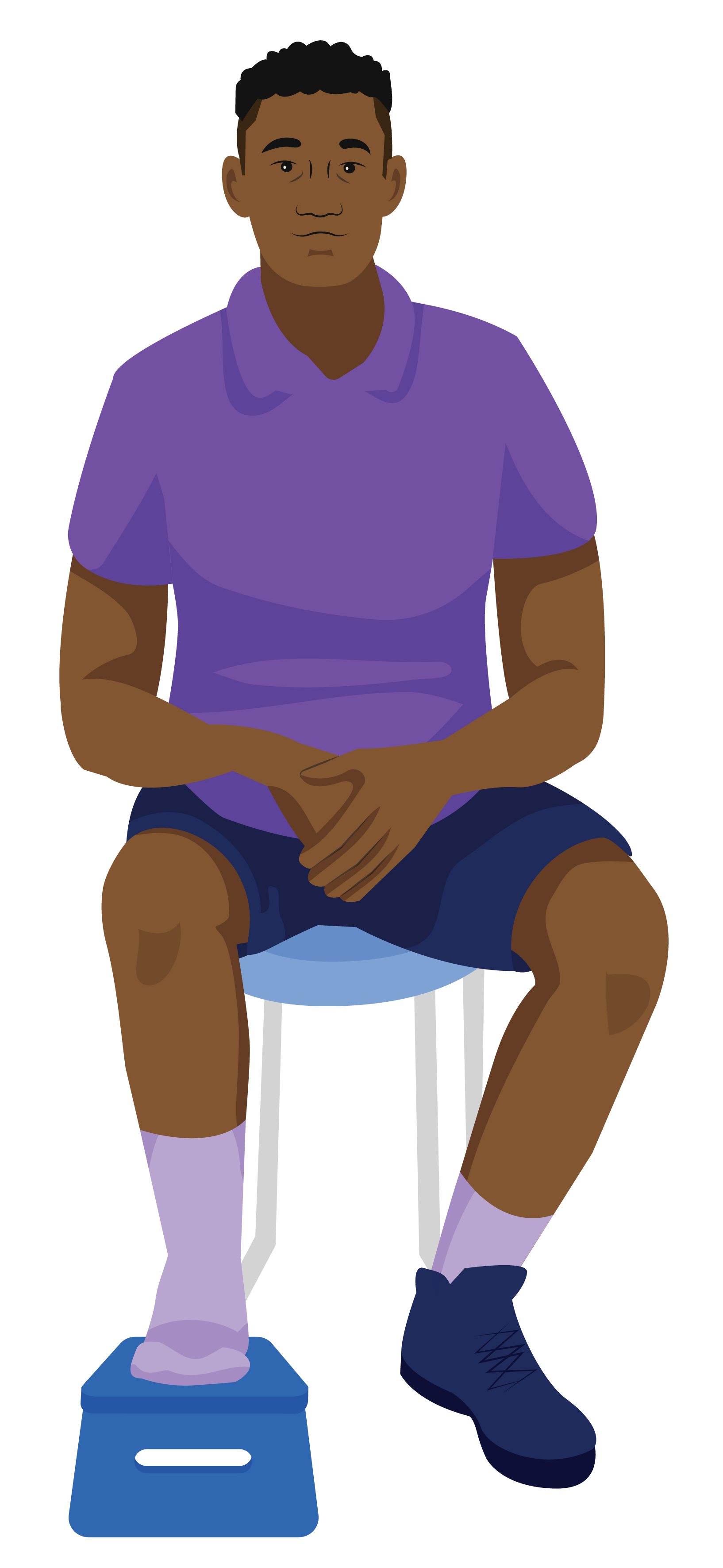 Khari sitting in a chair with his right foot propped up on a small stool