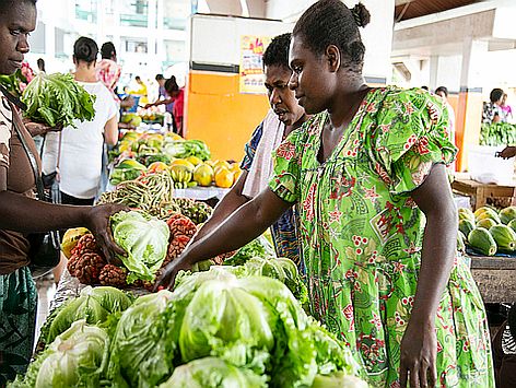 Person buying vegetables at a market