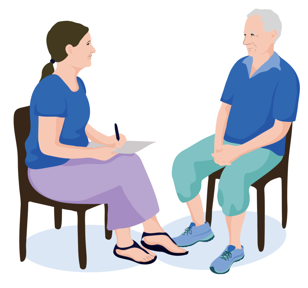 A health worker and Jensen sit down to speak.