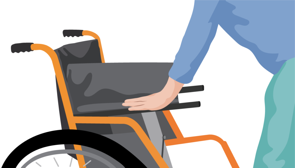 A person stands in front of the wheelchair and presses their hands down on the seat rails.