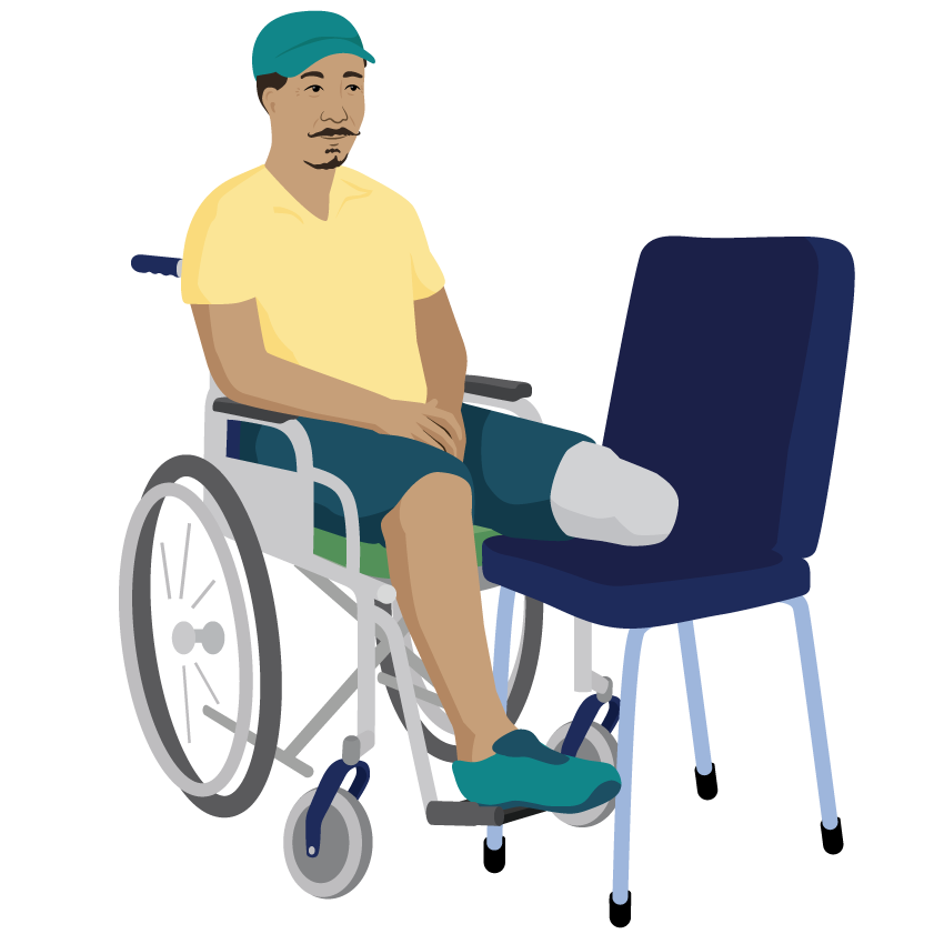 A man sits in his wheelchair with his left below knee amputation supported on a chair.