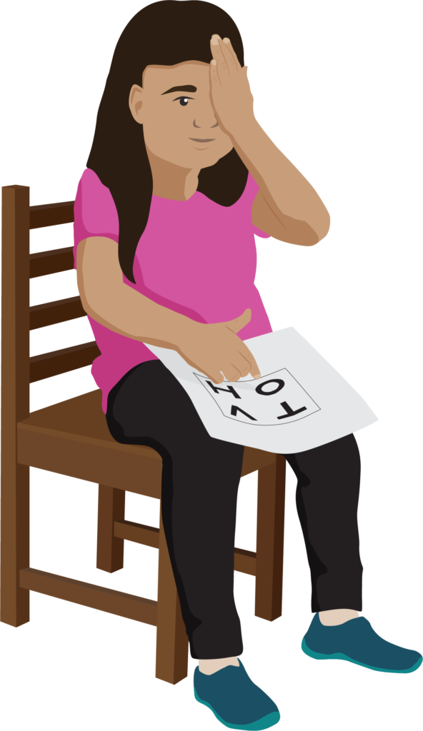 A child sits on a chair. The child covers their left eye with their left hand. They point to a letter on the card with their right finger.