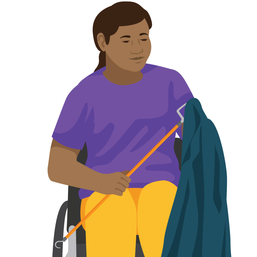 A person sitting in a wheelchair. They hold a dressing stick in their right hand. The s shaped hook guides the sleeve up the arm.