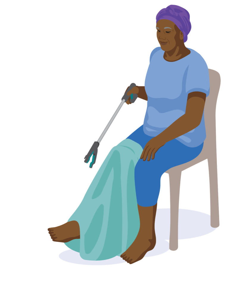 A person is sitting on a chair. They hold a reach and grab tool in their right hand with the trigger handle released. Their skirt is pulled over their right leg.