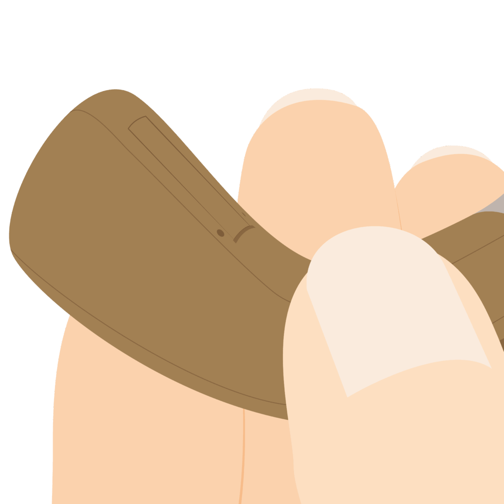 Close up of pin hole at top of battery door on a behind-the-ear hearing aid.